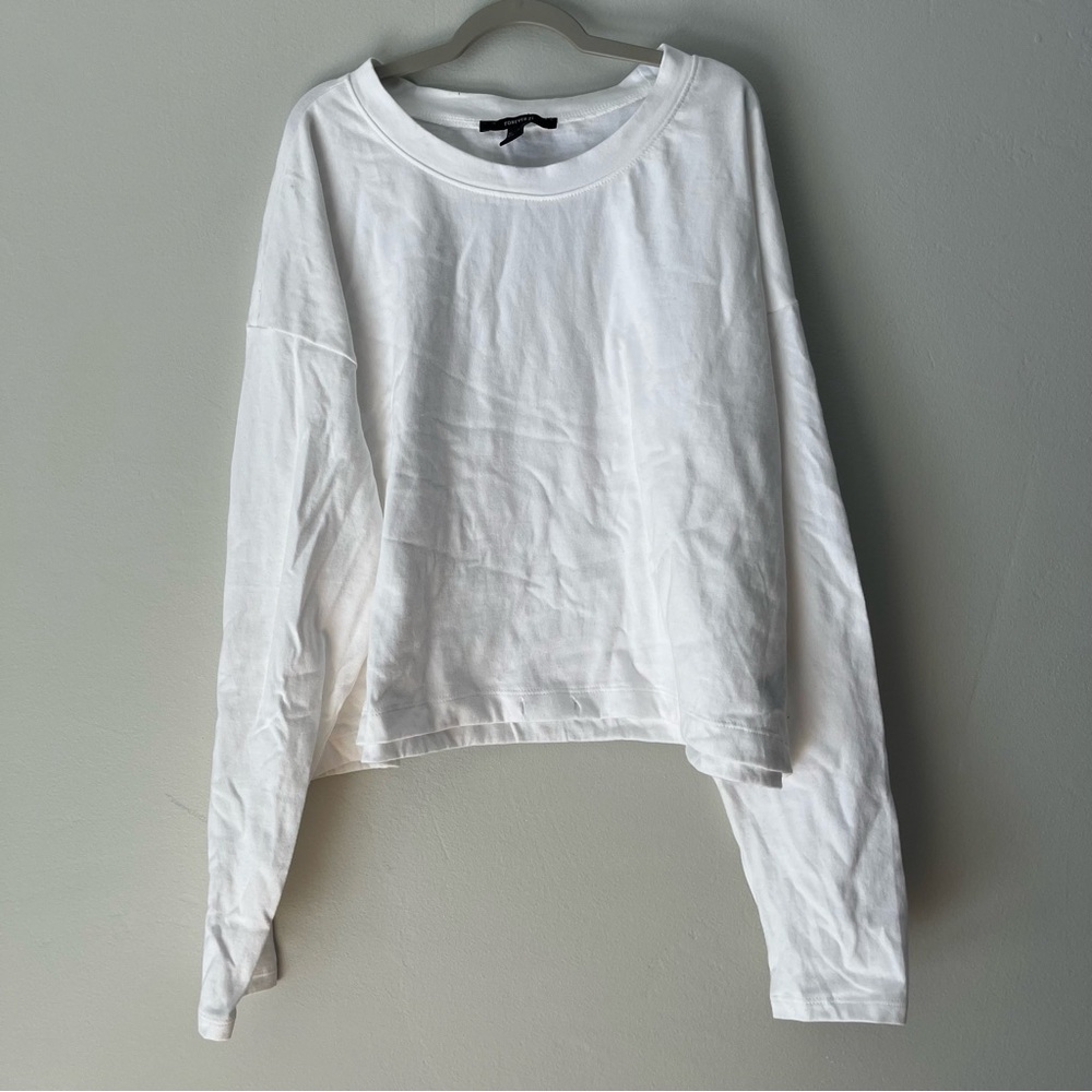 White long sleeve with lost strings at bottom